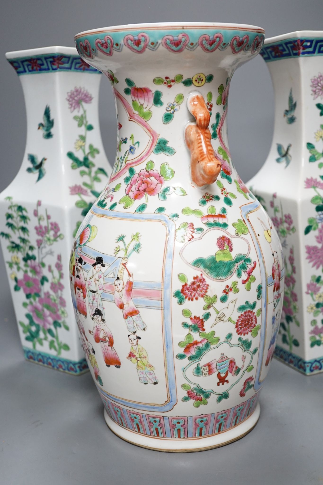 A pair of Chinese famille rose square baluster vases, and another famille rose vase, 37cm